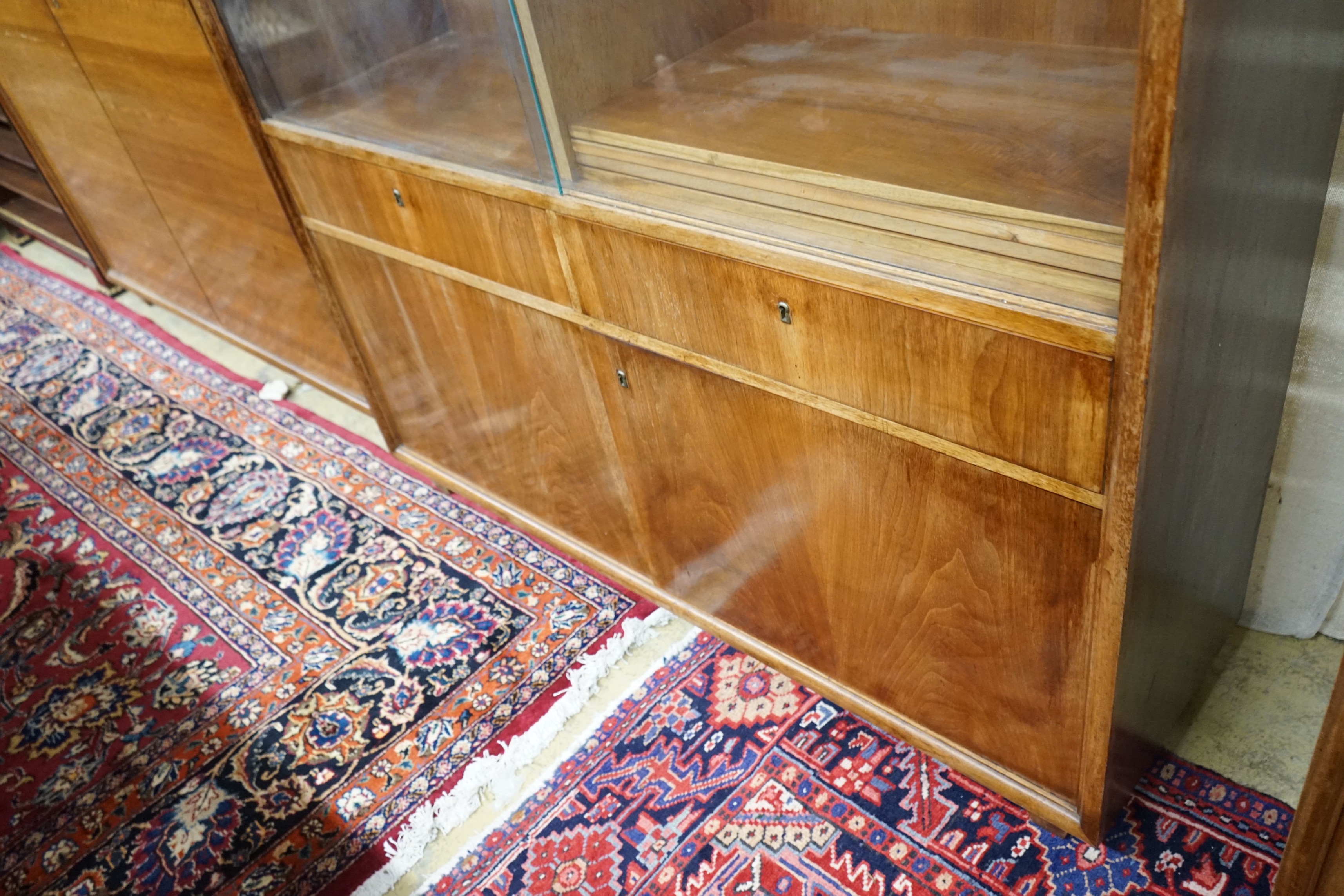 A mid century walnut bookcase by Georg Schoettle, Stuttgart, width 135cm, depth 40cm, height 160cm